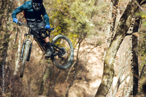 Close up of Boy jumping with enduro mtb bike in bike park
