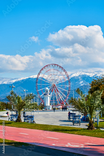 Ferris wheel on the embankment of the city of Batumi. Wonderful view of the city and mountains
