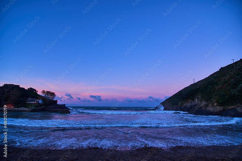 beautifully colored sunset on a rocky beach