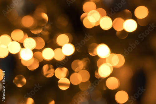 Blurry Christmas tree lights with bokeh. Celebration and new year concept. Abstract background with copy space