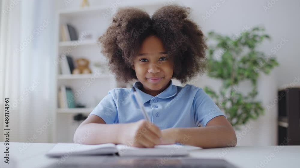 Little girl studying in front of laptop, having video call, talking to tutor Little girl studying in front of laptop, having video call, talking to tutor