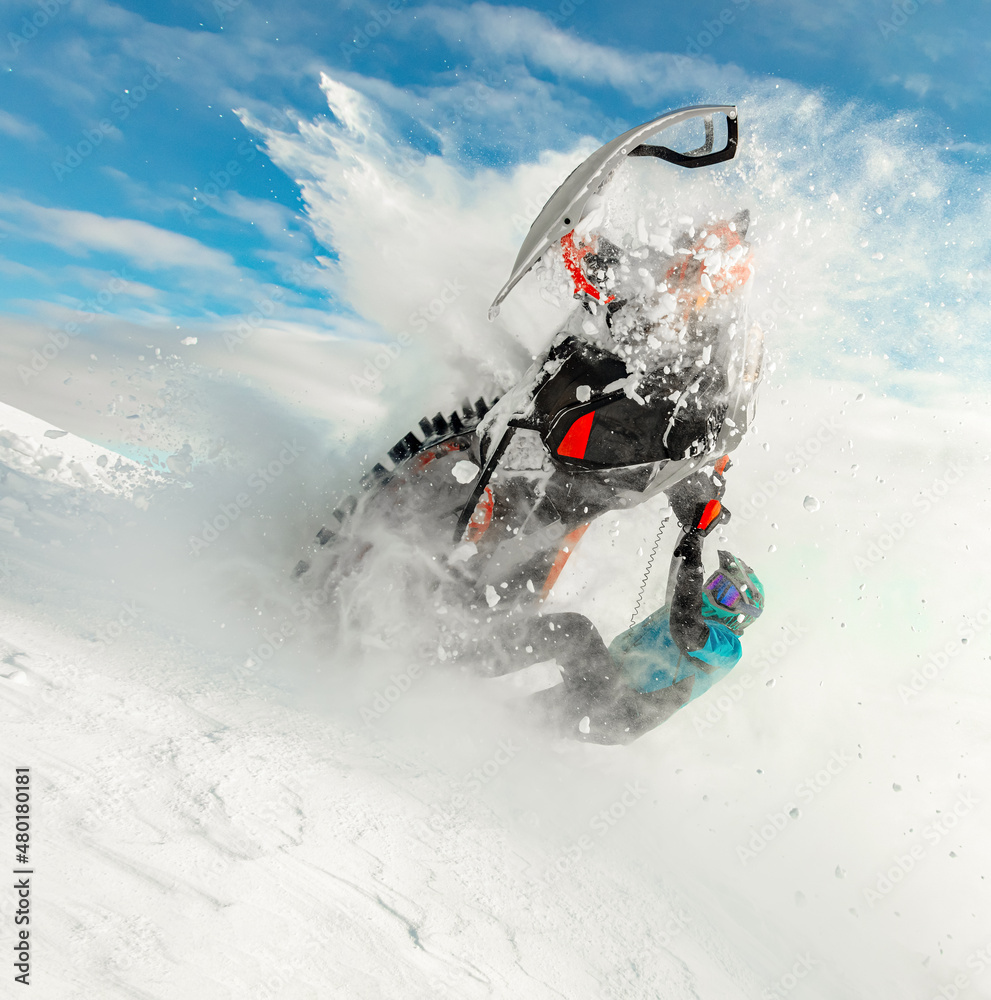 extreme driving of a mountain snowmobile. a sports snowmobiler in