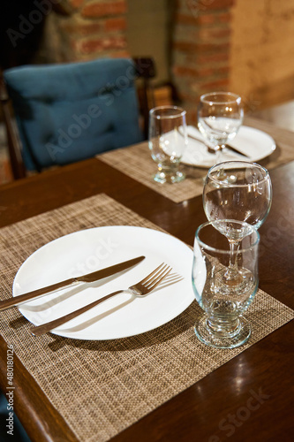 A table with clean dishes in a cozy cafe with a fireplace