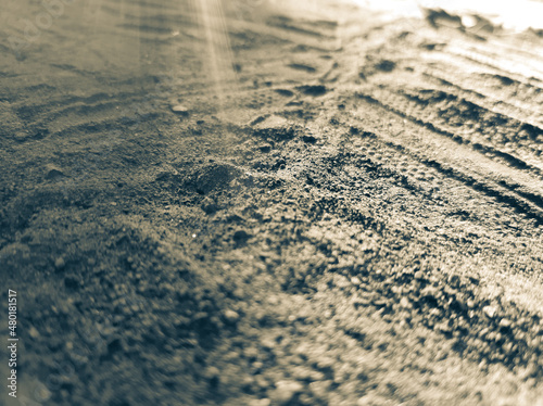 Tire tracks on the sand.