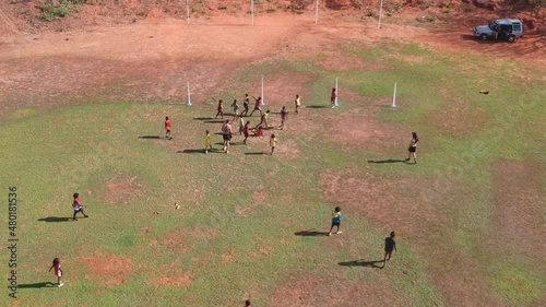 Indigenous Australian Aboriginal people Playing Australian Football Rules (AFL) on the Tiwi Islands on a Remote Island off of Northern Territory Australia photo
