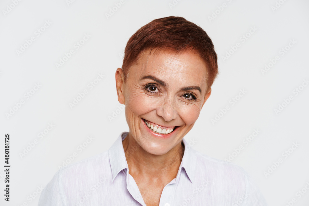 Ginger senior woman with short hair smiling and looking at camera Ginger senior woman with short hair smiling and looking at camera
