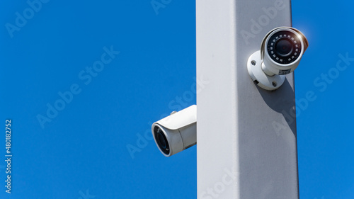 CCTV surveillance security camera video equipment on pole with blue sky outdoor area safety system area control and copy space