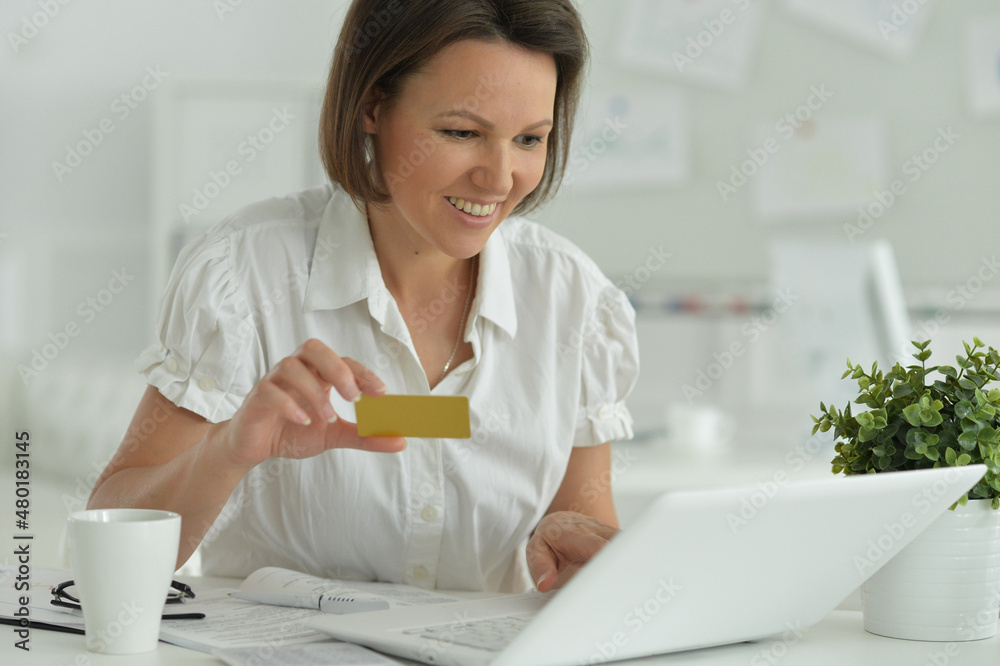 Beautiful woman with laptop and credit card Beautiful woman with laptop and credit card