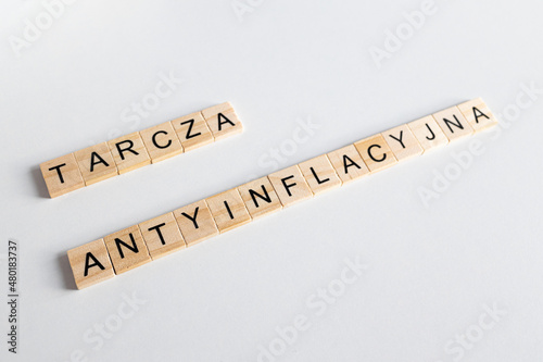 Tarcza antyinflacyjna, napis z drewnianych literek na jednloitym tle
