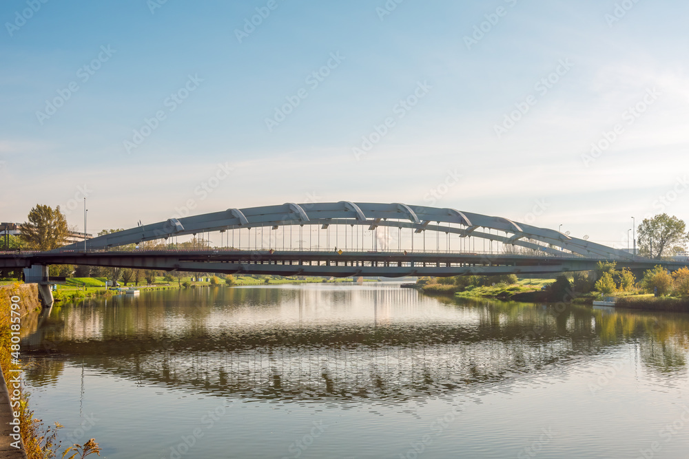 Fototapeta premium Kotlarski Bridge (Most Kotlarski) over the Vistula River in Krakow the longest arched bridge in Poland, without columns on the river.