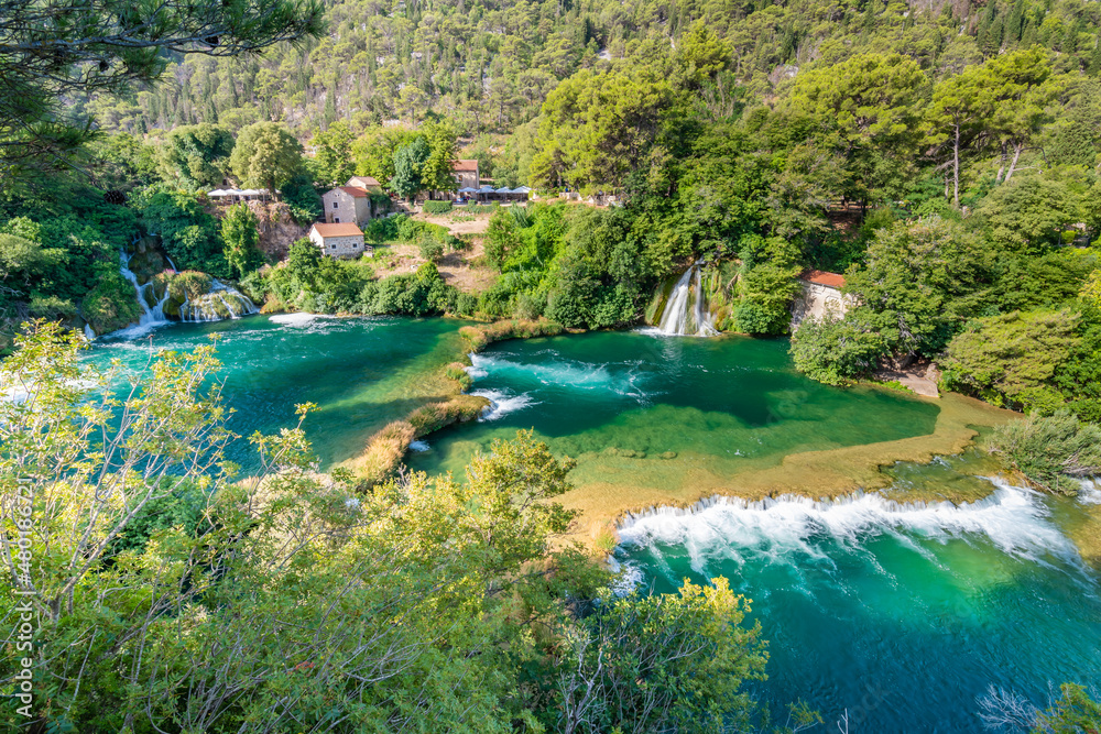 Waterfalls at Krka river, Croatia. Part of the Skradinski Buk waterfall. Famous place in nature park - beautiful tourist destination in Croatia. Fresh green nature, summer weather.