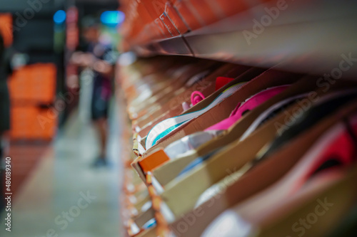 Принти на полотні a lot of sports sneakers in the orange paper boxes on shelf ready to sales