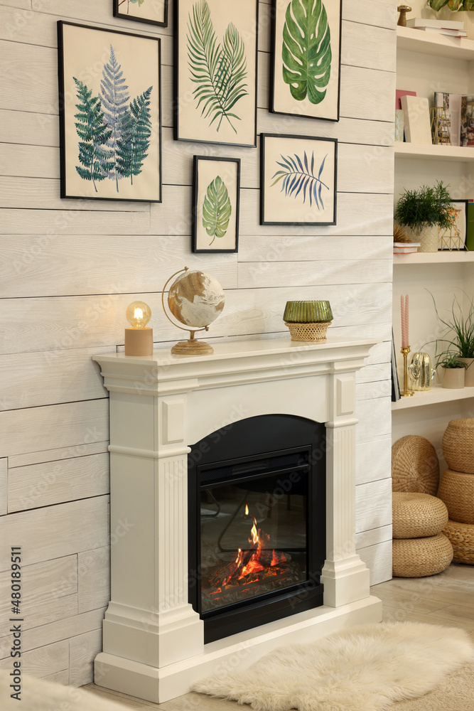 Stylish room interior with beautiful floral pictures and decorative fireplace Stylish room interior with beautiful floral pictures and decorative fireplace