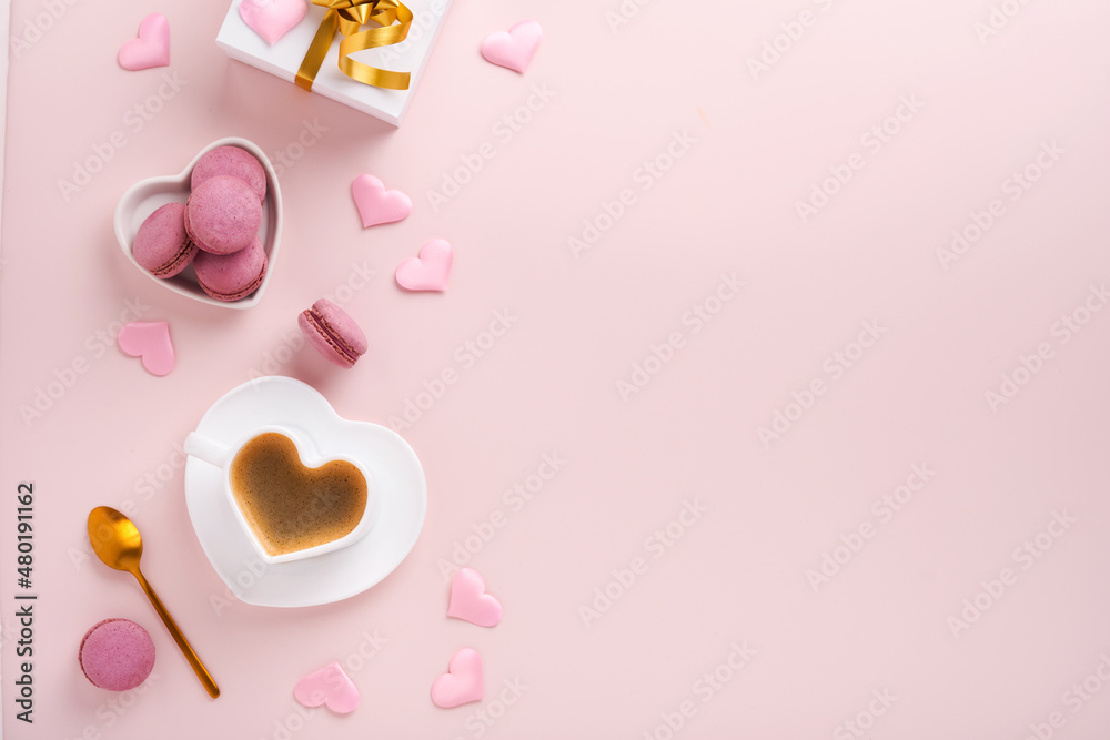 Valentines Day card. Pink empty envelope with blank white note mockup inside, macaron macaroon cookie and heart shaped coffee cup on pink background. 8 March, Valentines Day, Birthday card. Mock up.
