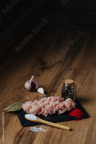 raw minced fresh meat on a wooden background spice pepper wooden spoon