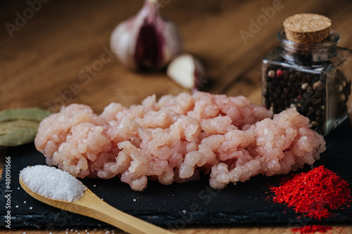 raw minced fresh meat on a wooden background spice pepper wooden spoon