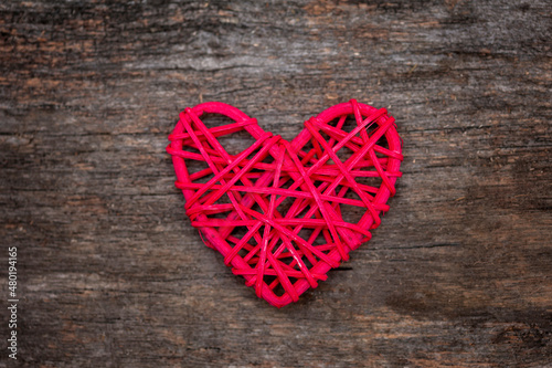 Red wooden heart on wooden dark background