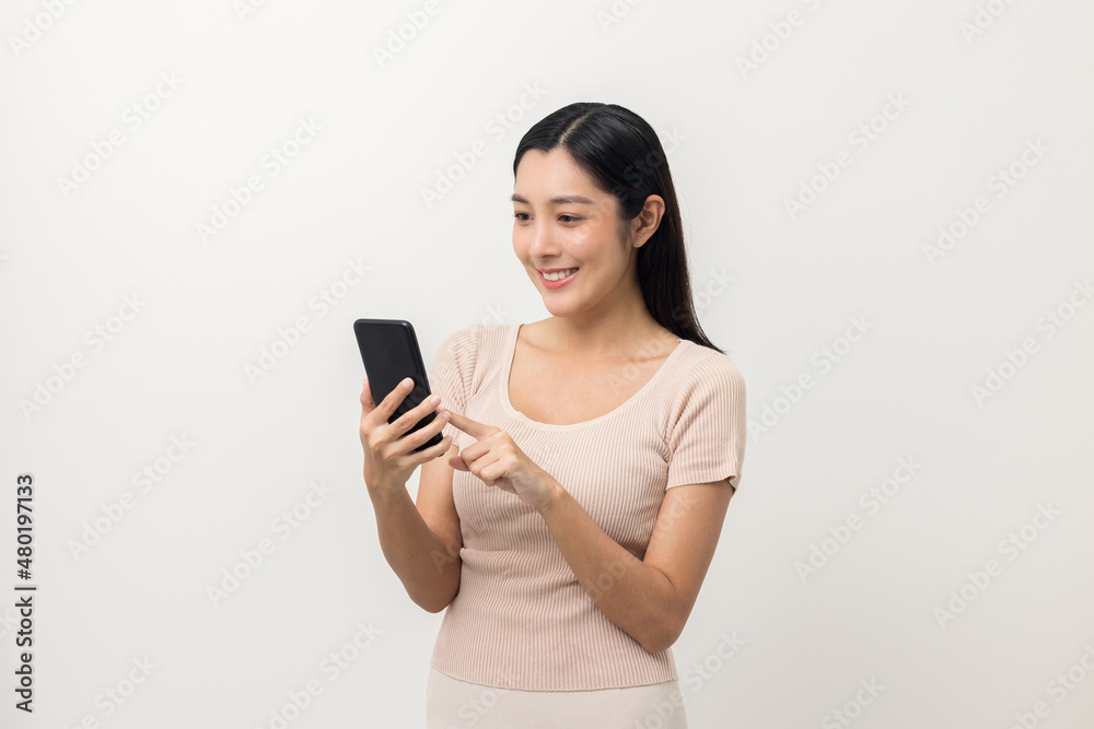 Excited Beautiful young asian woman using smartphone mobile standing on isolated white background. Playing game on smartphone winning victory moment. Very happy enjoy and fun relax time Excited Beautiful young asian woman using smartphone mobile standing on isolated white background. Playing game on smartphone winning victory moment. Very happy enjoy and fun relax time