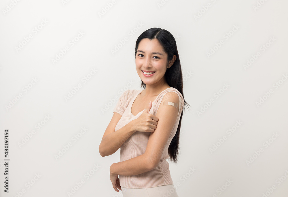 Vaccination. Young beautiful asian woman getting a vaccine protection the coronavirus. Smiling happy female showing arm after receiving vaccination. On isolated white background. Vaccination. Young beautiful asian woman getting a vaccine protection the coronavirus. Smiling happy female showing arm after receiving vaccination. On isolated white background.