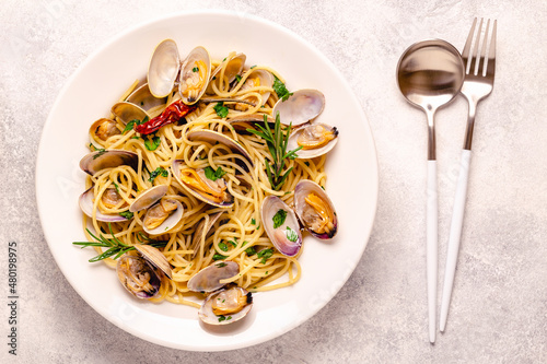 Seafood pasta with clams Spaghetti alle Vongole on a light background