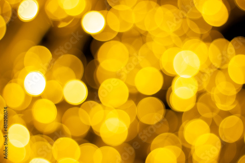 Golden bokeh background. Concept of Christmas and Happy New Year. Festive abstract holiday background with copy space.