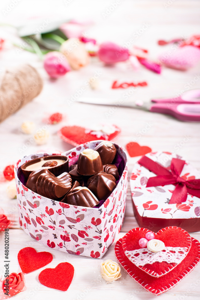 Chokolate box in shape of heart on white wooden table valentine background low angle view