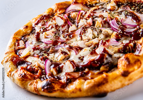 Pizza with chicken and barbeque sauce . Italian pizza