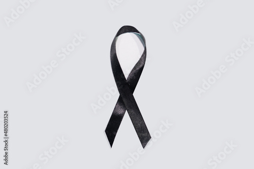 Black awareness ribbon on white background. Mourning and melanoma symbol