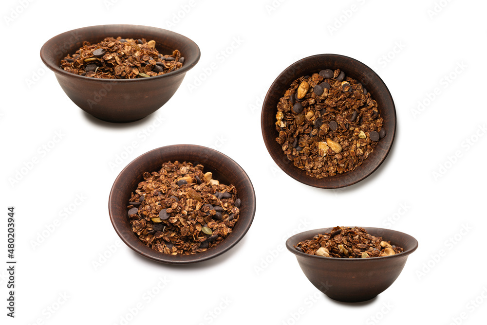 Chocolate granola cereal with nuts in a bowl background. Chocolate granola cereal with nuts in a bowl background.