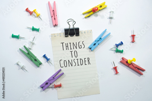 Text sign showing Things to Consider with copy space, stationery items in white background 