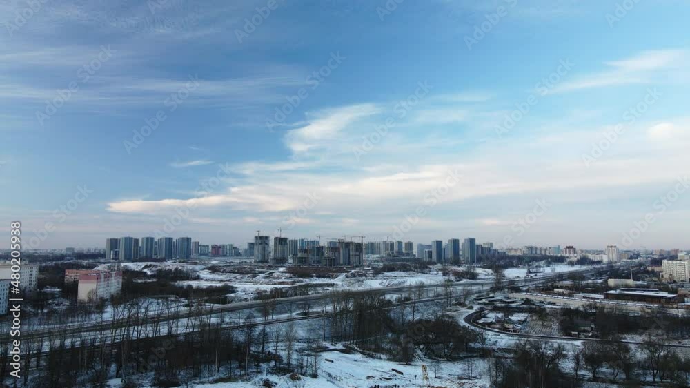 Flying in a suburban park. City blocks are visible. Winter cityscape. Aerial photography. Flying in a suburban park. City blocks are visible. Winter cityscape. Aerial photography.