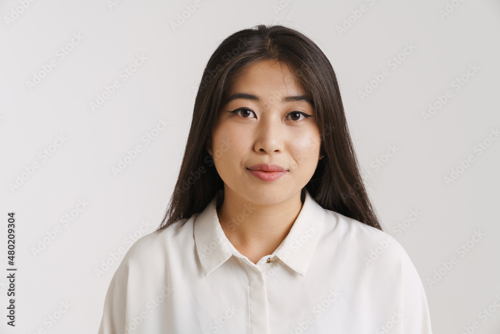 Young asian woman dressed shirt posing and looking at camera Young asian woman dressed shirt posing and looking at camera