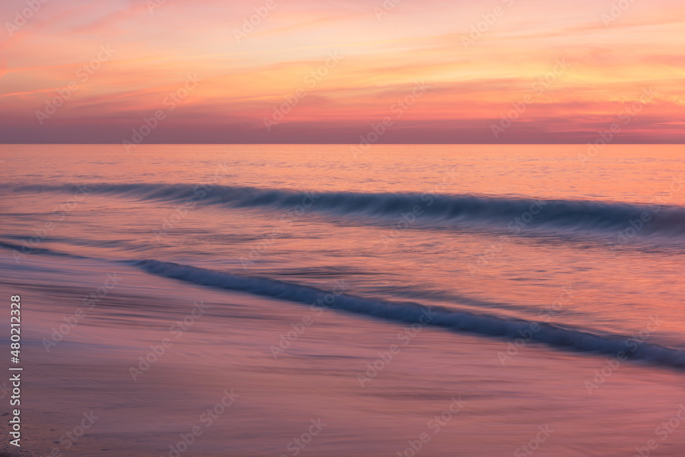 Wave movement in the reddish sunset of Alentejo