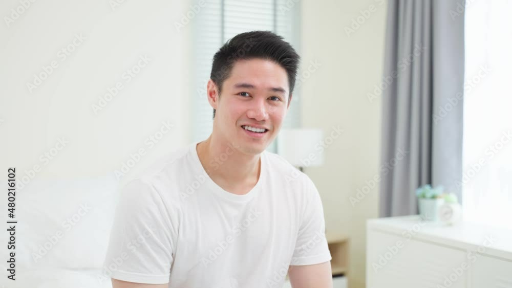 Portrait of Asian handsome male in pajamas smile and looking at camera. Portrait of Asian handsome male in pajamas smile and looking at camera.