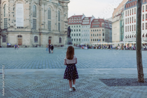 girl looks at the Frauenkirche Dresden Church of our lady