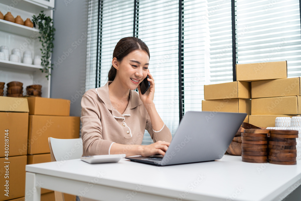 Asian beautiful woman sell vase product and check sale order on laptop. Asian beautiful woman sell vase product and check sale order on laptop.