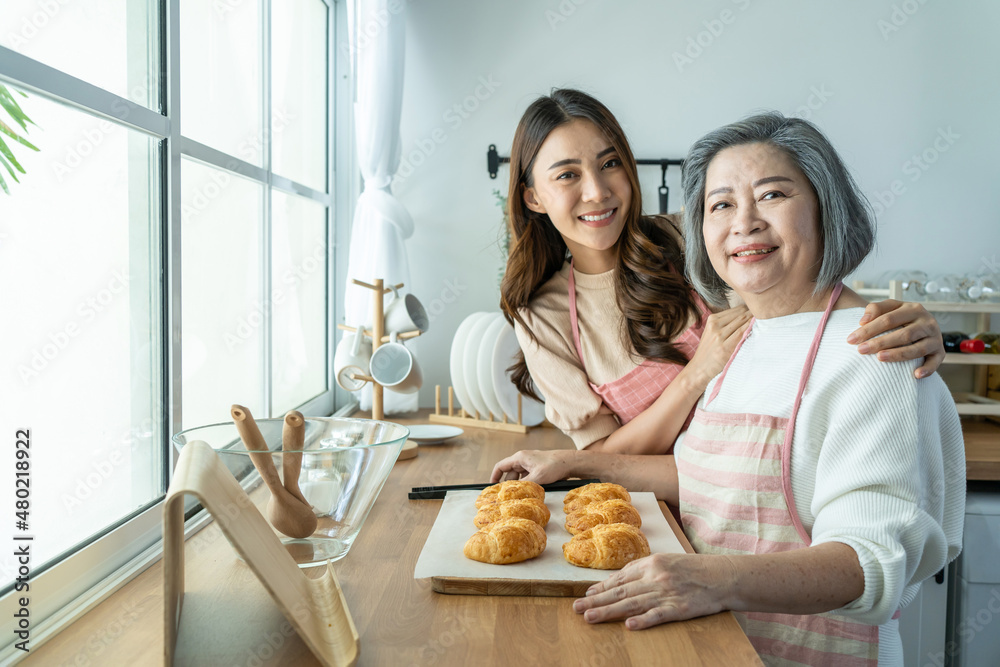 Portrait of Asian lovely family, young daughter stand with old mother. 