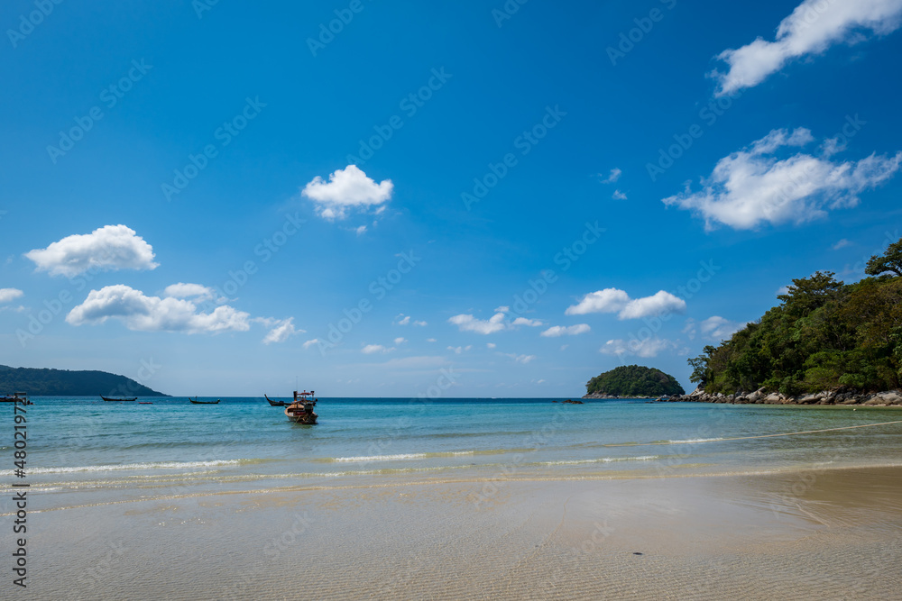 Kata beach in Phuket, Thailand, beach with clear water, white and golden sand, blue sky, in tropical vacation area.  a beach holiday  photo with copyspace.