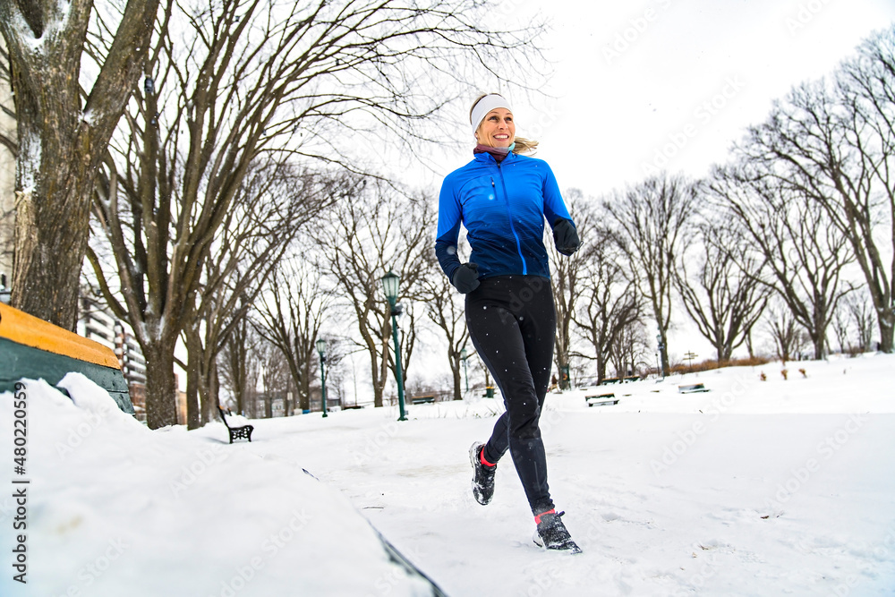 Nice Young Woman Running in Snowy Park