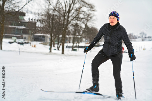 Woman cross country skiing on a winter morning in