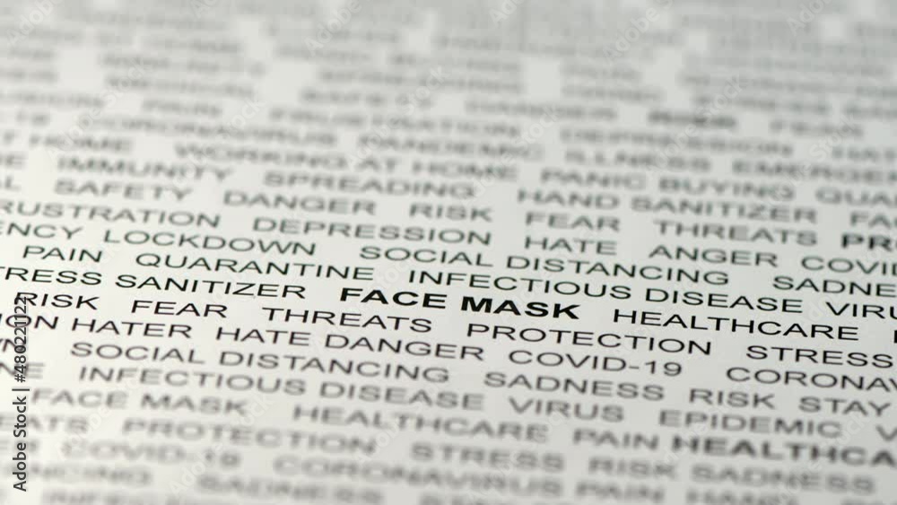 White paper with black coronavirus related text on it. Camera pointed downwards while slowly moving forward. Defocused. Selective focus. Blurred. White paper with black coronavirus related text on it. Camera pointed downwards while slowly moving forward. Defocused. Selective focus. Blurred.