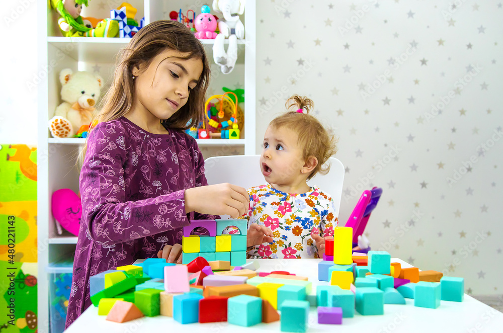 The child plays with toys in the room. Selective focus. The child plays with toys in the room. Selective focus.