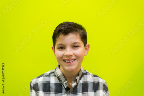 Portrait of smiling boy against yellow background