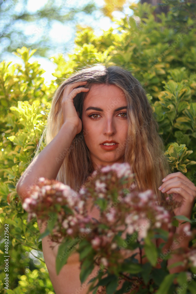 Portrait of young, beautiful blonde woman with wavy hair posing in nature Portrait of young, beautiful blonde woman with wavy hair posing in nature