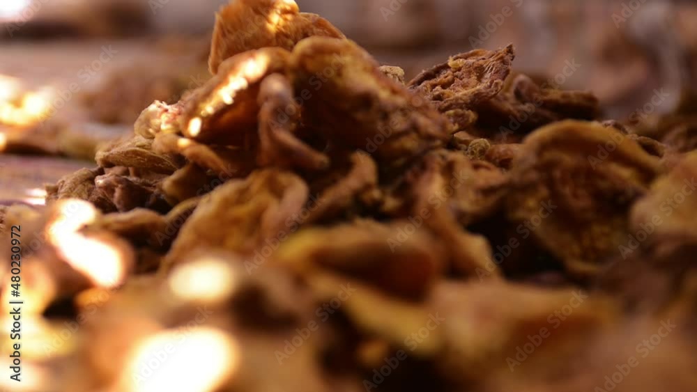 person sorting through dried fruits in the market person sorting through dried fruits in the market
