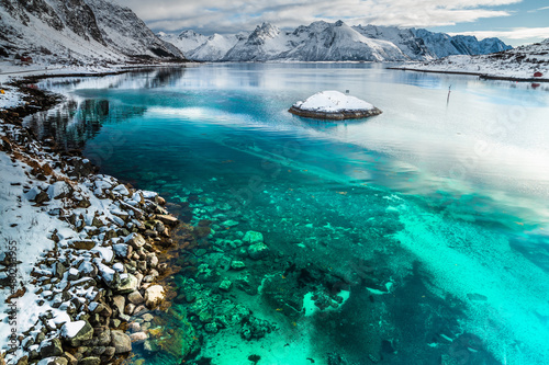 Green water background with snowy mountains background in Lofoten islands