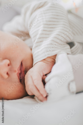 Newborn baby child sleeping. Soft focus close-up macro of newborn baby lips and hand.