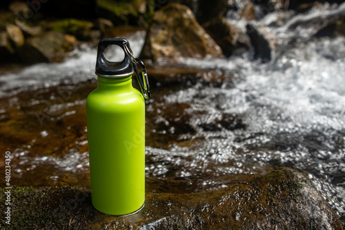 an Aluminium thermos Water Bottle in the nature background