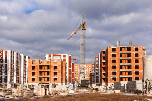 Construction Buildings. High-rise brick Houses under Construction. New Neighborhood of modern High-rise Buildings.