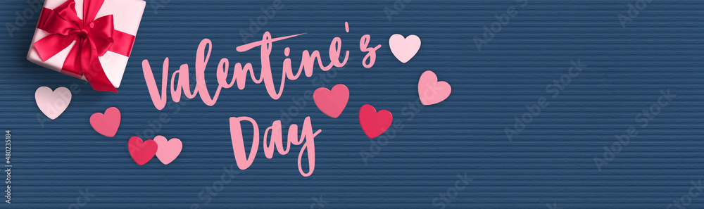 Valentine's Day background. Gift box and hearts on a blue paper background. Valentine's Day background. Gift box and hearts on a blue paper background.